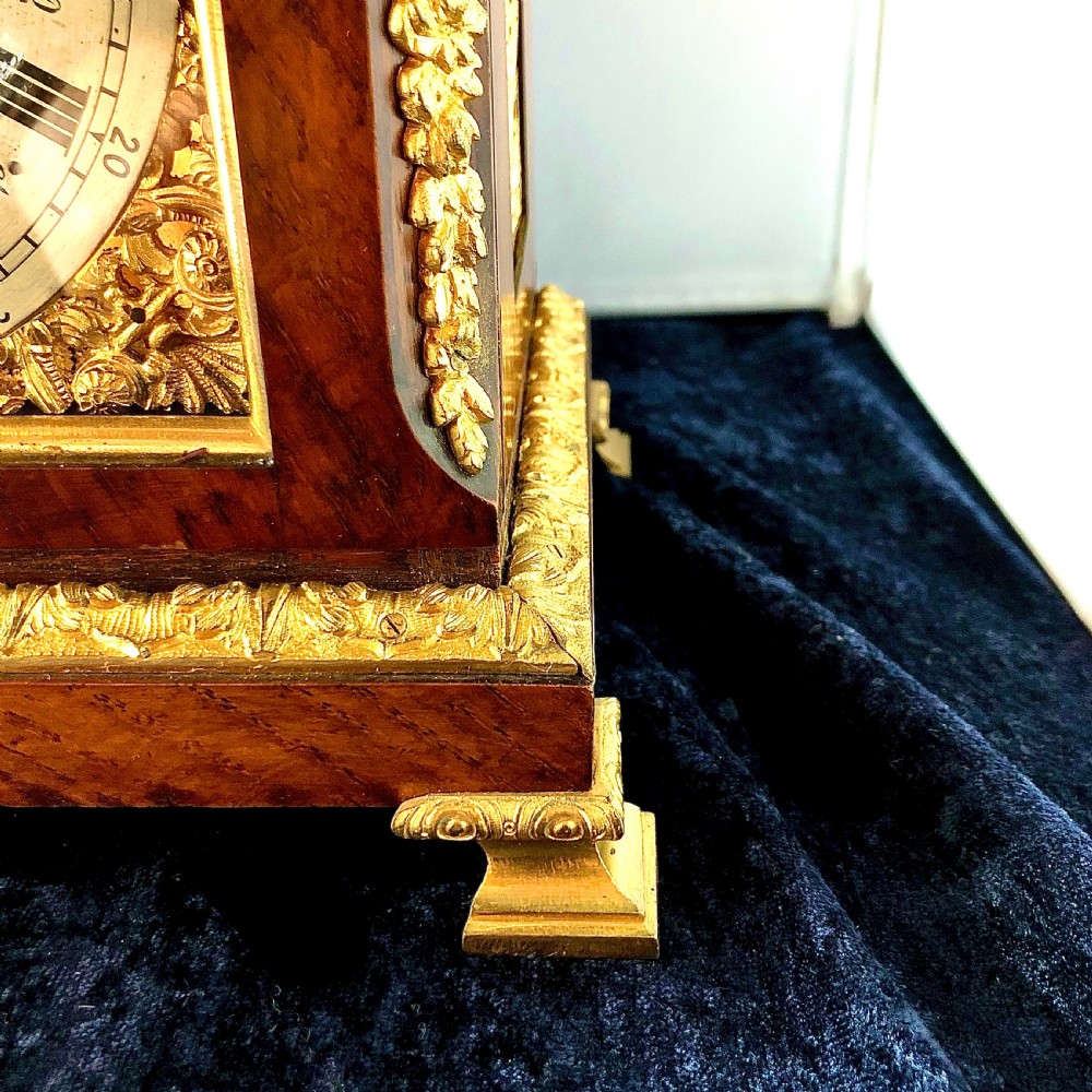 A late 19th-century mahogany bracket clock featuring an arched silvered dial, gilt-bronze caryatid mounts, and a brass finial top. View XI