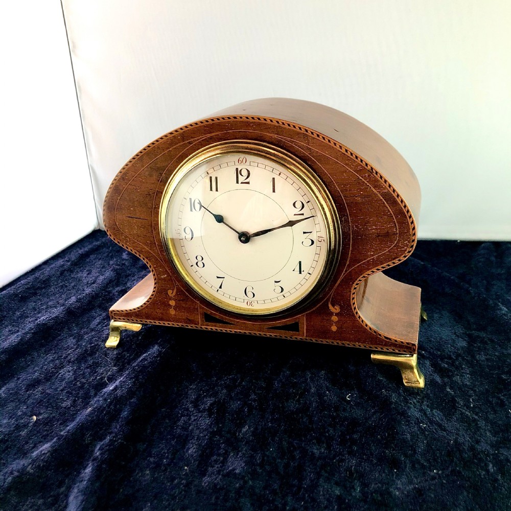 An Art Nouveau mahogany mantel clock timepiece. 