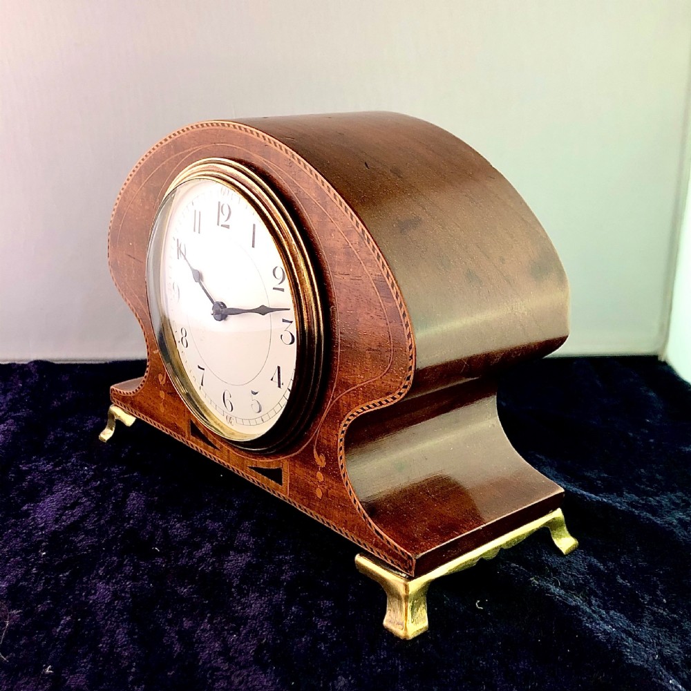 An Art Nouveau mahogany mantel clock timepiece.  View II