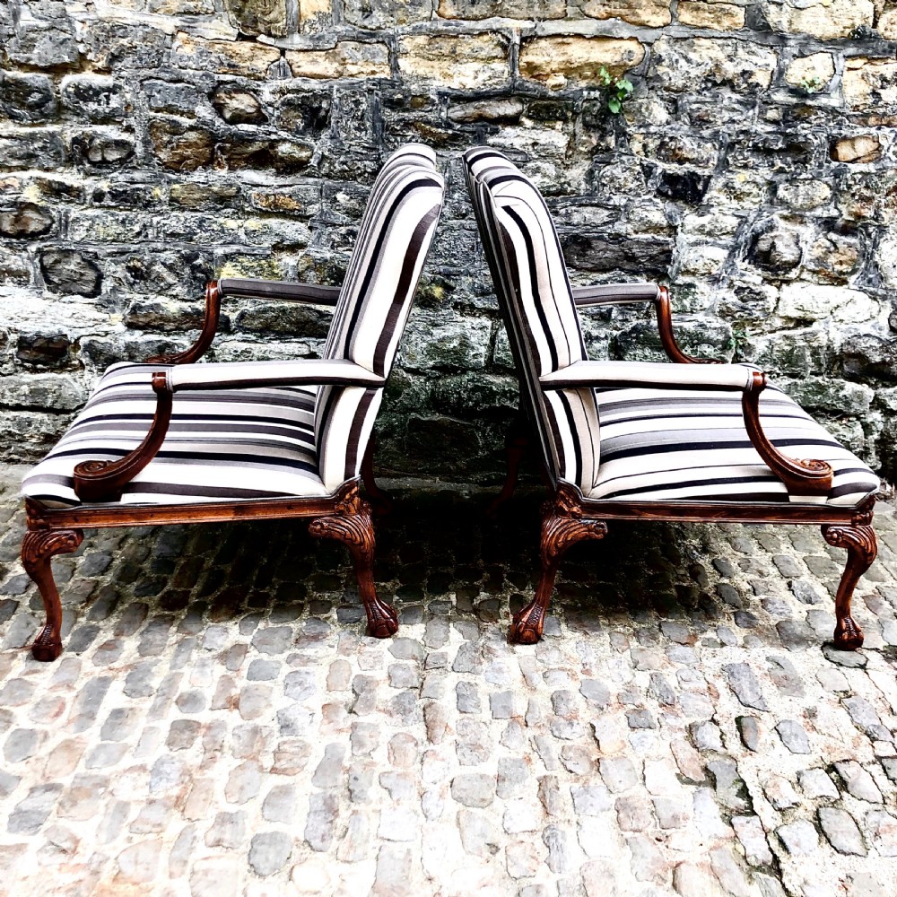 A pair of carved walnut Gainsborough armchairs upholstered in vertical striped neutral fabric featuring cabriole legs with claw and ball feet. View II