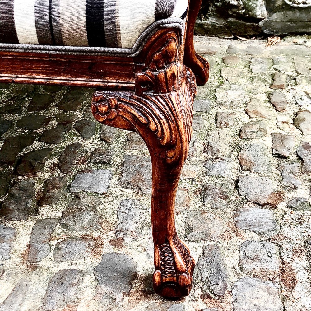 A pair of carved walnut Gainsborough armchairs upholstered in vertical striped neutral fabric featuring cabriole legs with claw and ball feet. View III
