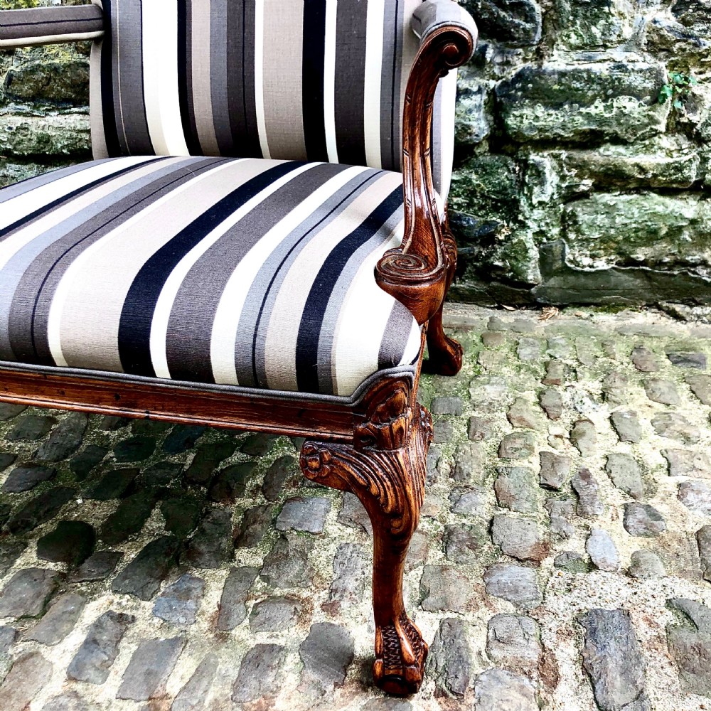 A pair of carved walnut Gainsborough armchairs upholstered in vertical striped neutral fabric featuring cabriole legs with claw and ball feet. View IV