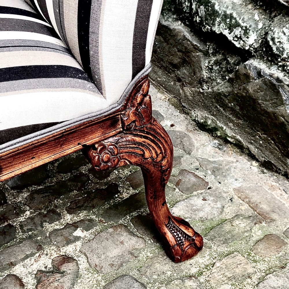 A pair of carved walnut Gainsborough armchairs upholstered in vertical striped neutral fabric featuring cabriole legs with claw and ball feet. View VI