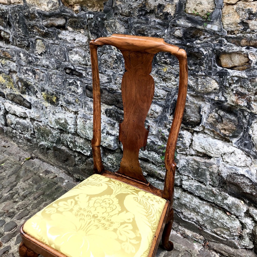 A Queen Anne walnut side chair featuring a vasiform back splat, cabriole front legs with pad feet, and a yellow patterned silk upholstered seat. View II