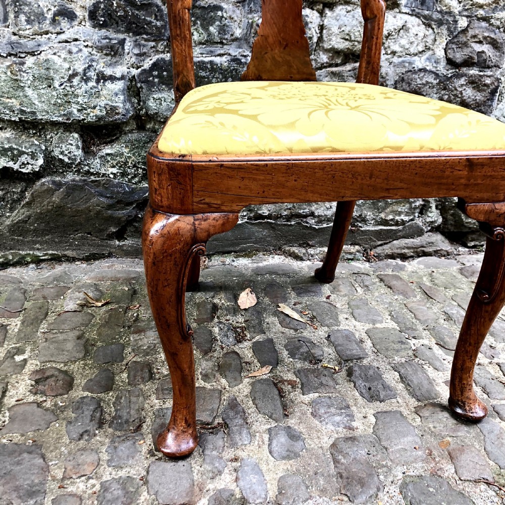 A Queen Anne walnut side chair featuring a vasiform back splat, cabriole front legs with pad feet, and a yellow patterned silk upholstered seat. View III