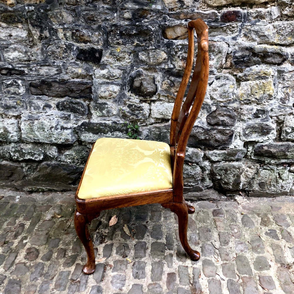 A Queen Anne walnut side chair featuring a vasiform back splat, cabriole front legs with pad feet, and a yellow patterned silk upholstered seat. View IV