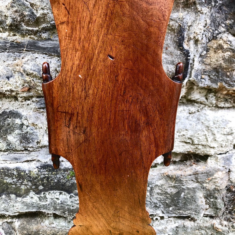 A Queen Anne walnut side chair featuring a vasiform back splat, cabriole front legs with pad feet, and a yellow patterned silk upholstered seat. View V