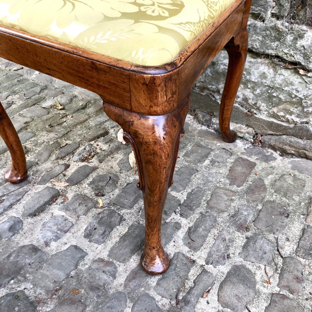 A Queen Anne walnut side chair featuring a vasiform back splat, cabriole front legs with pad feet, and a yellow patterned silk upholstered seat. View VII