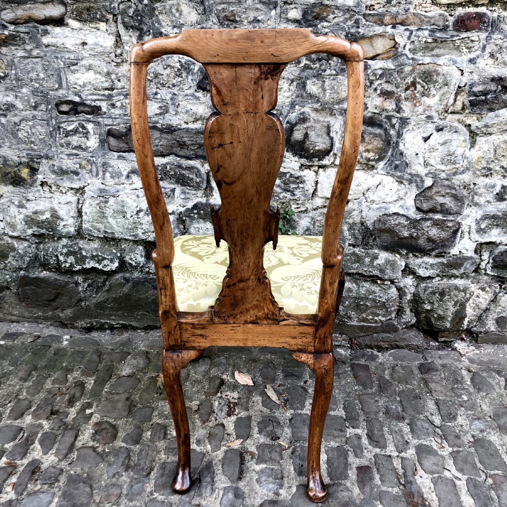 A Queen Anne walnut side chair featuring a vasiform back splat, cabriole front legs with pad feet, and a yellow patterned silk upholstered seat. View X