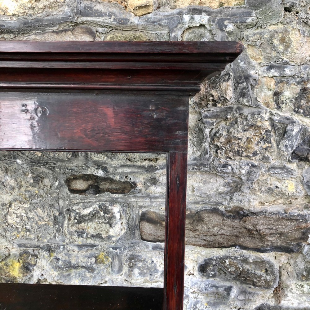 A dark oak 18th-century plate rack featuring three wide horizontal display shelves topped with a moulded cornice. View III