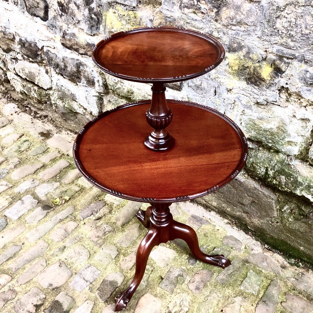 A late nineteenth-century mahogany two-tier wine table featuring two rounded circular trays on a central turned stem supported by a tripod base. View II