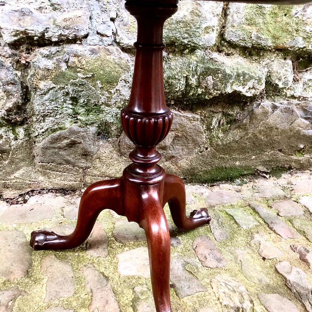 A late nineteenth-century mahogany two-tier wine table featuring two rounded circular trays on a central turned stem supported by a tripod base. View V