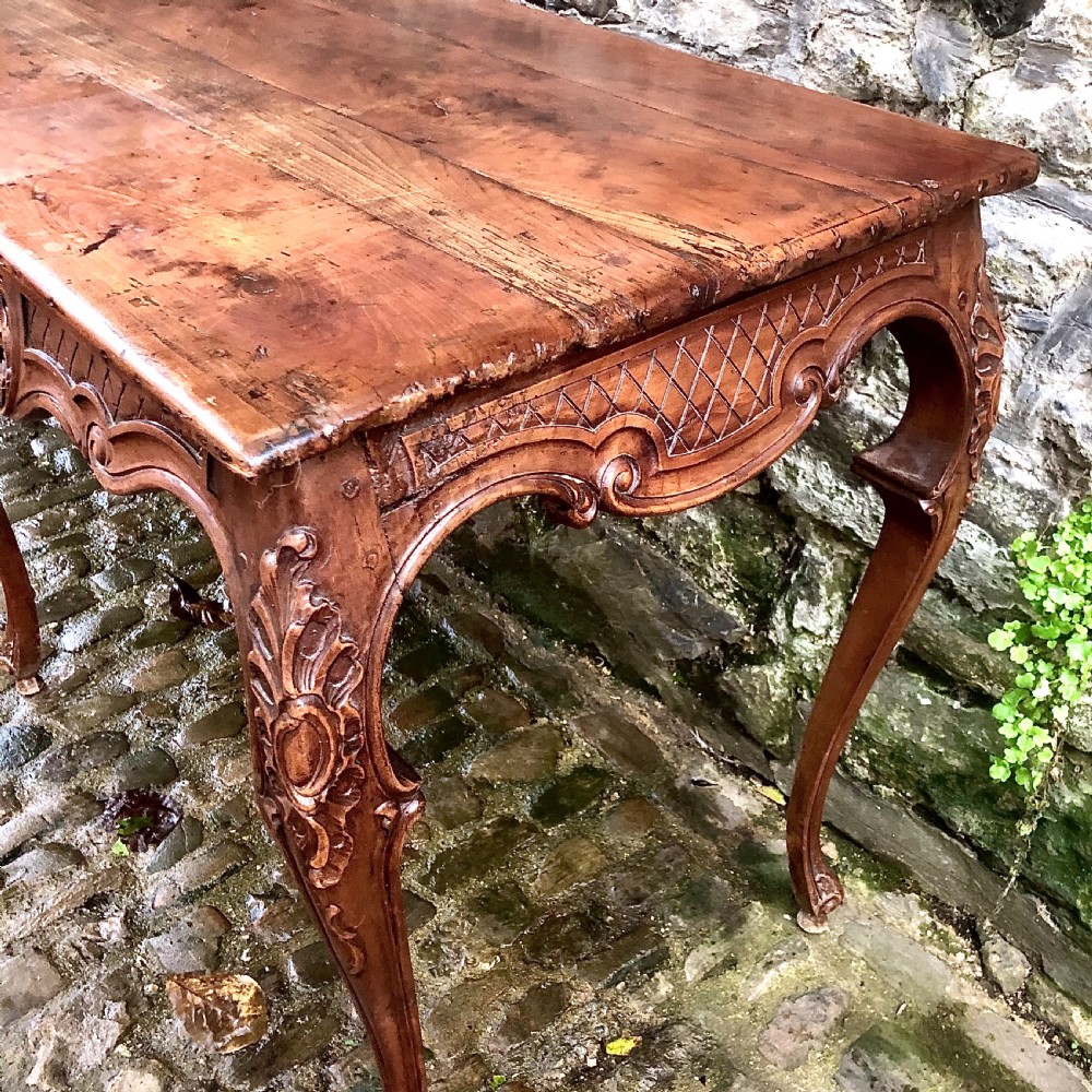 A French Louis XV style carved walnut centre table featuring cabriole legs and a decorative floral apron. View III