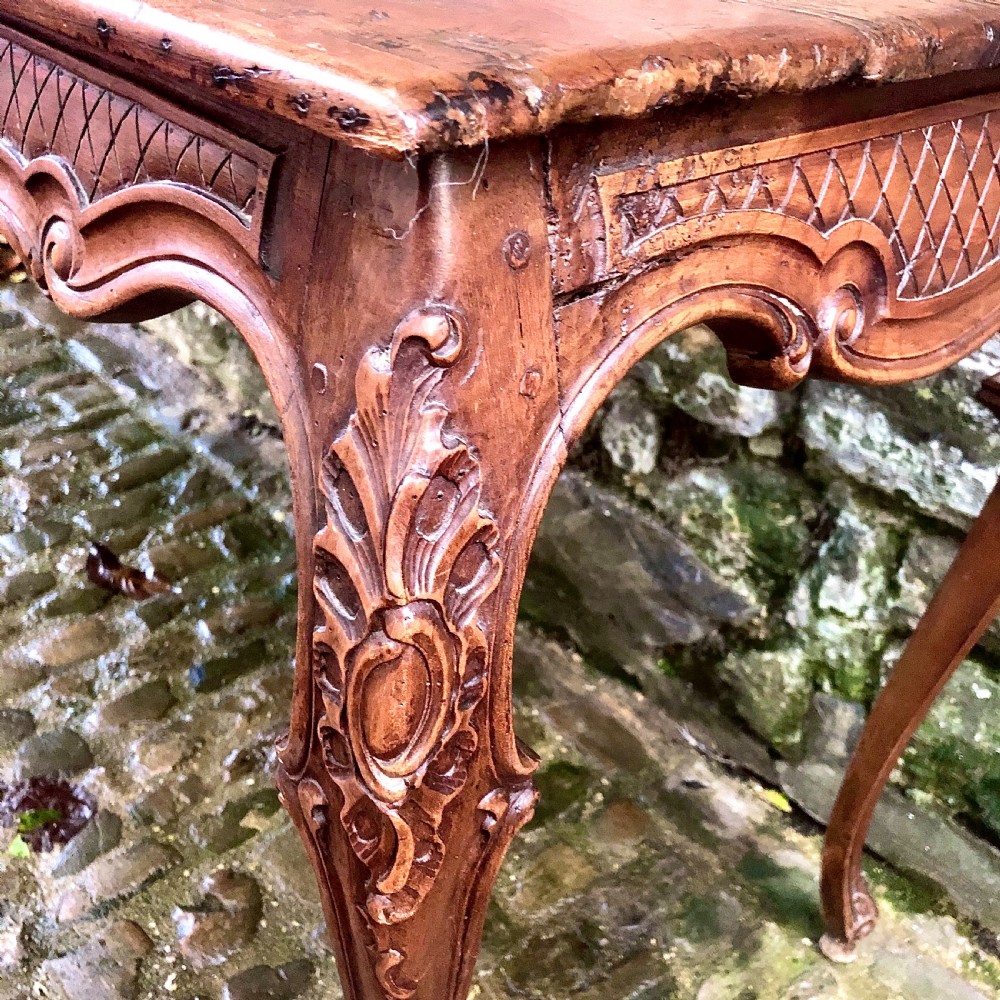 A French Louis XV style carved walnut centre table featuring cabriole legs and a decorative floral apron. View IV