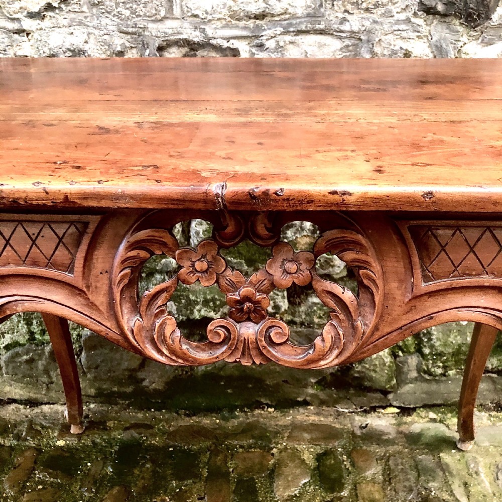 A French Louis XV style carved walnut centre table featuring cabriole legs and a decorative floral apron. View V