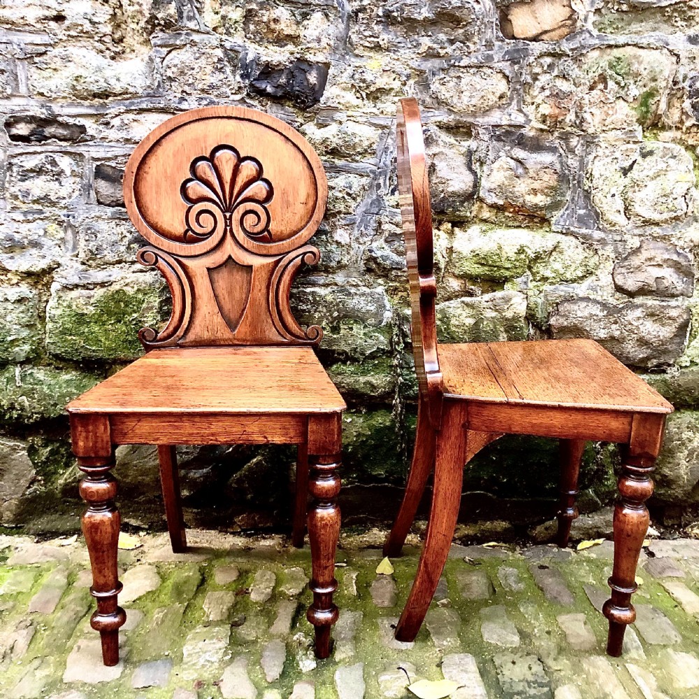 A pair of early Victorian oak hall chairs  View II