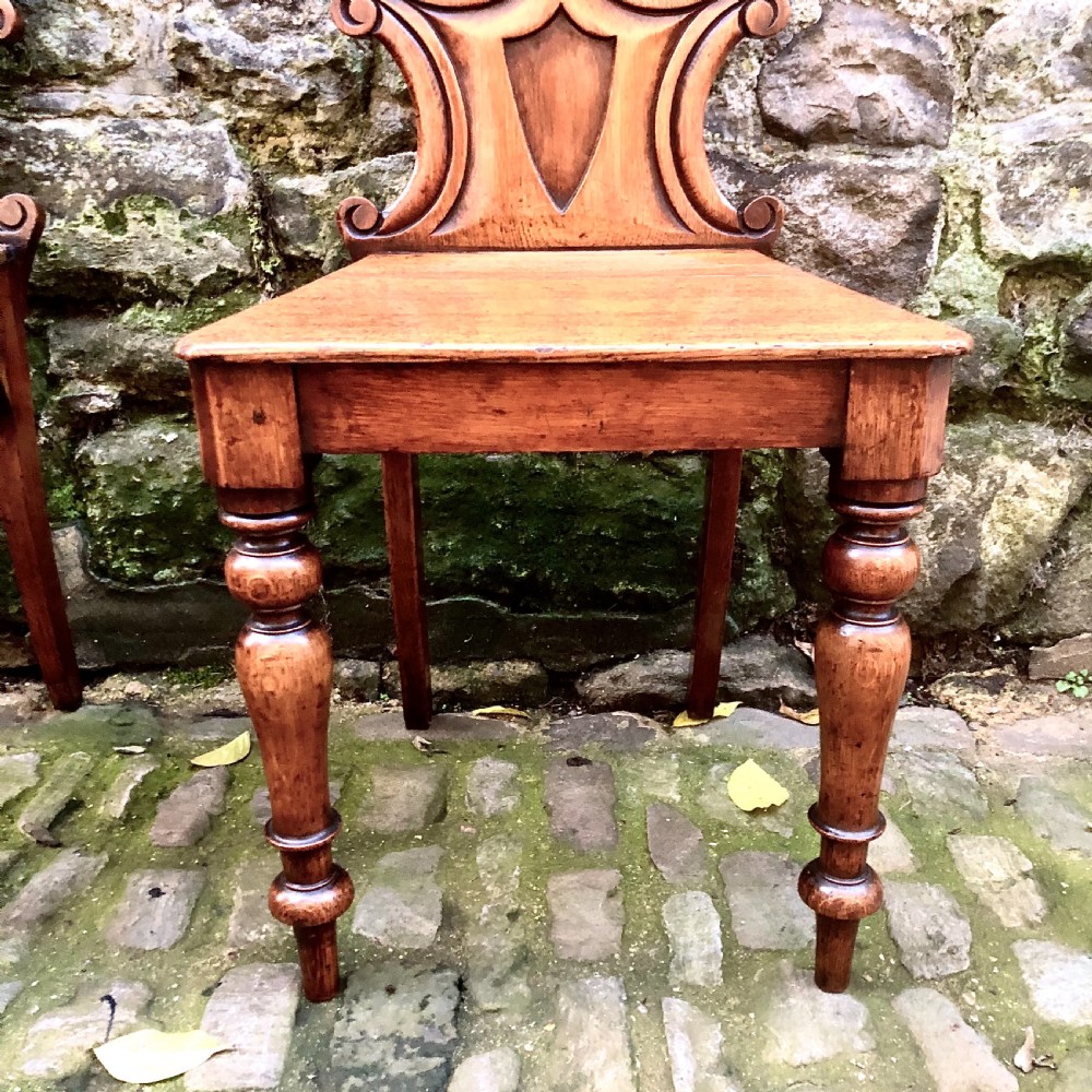 A pair of early Victorian oak hall chairs  View V