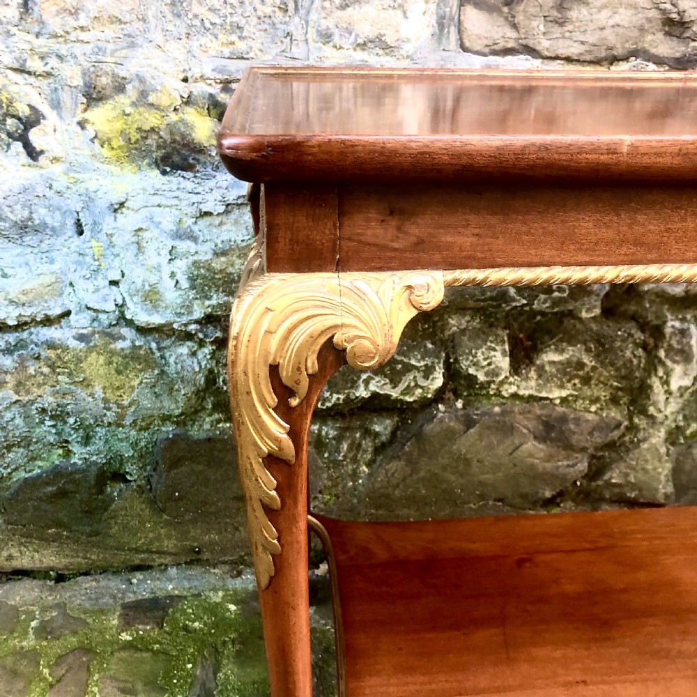 A late nineteenth-century two-tier walnut coffee table featuring carved gilded cabriole legs and a polished lower shelf. View IV