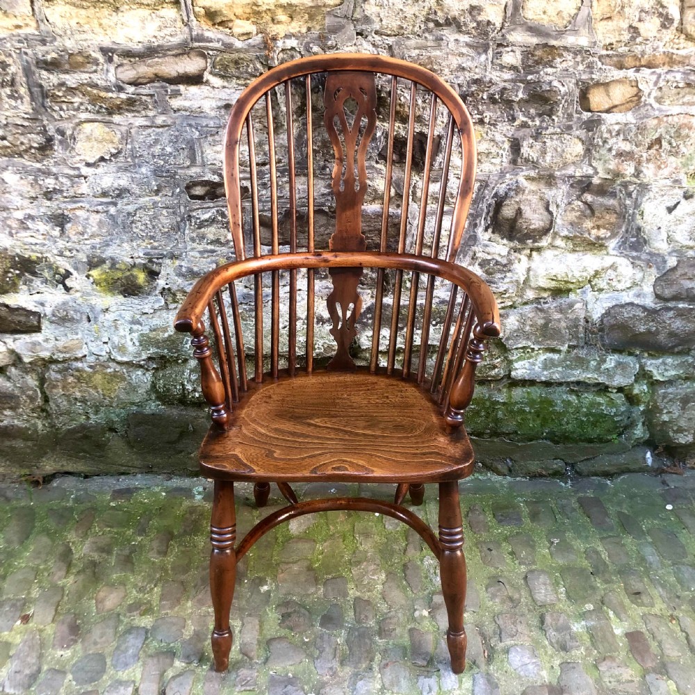 A mid-Victorian yew wood Windsor armchair featuring a hoop back, pierced central splat, turned legs, and a shaped wooden seat. View II