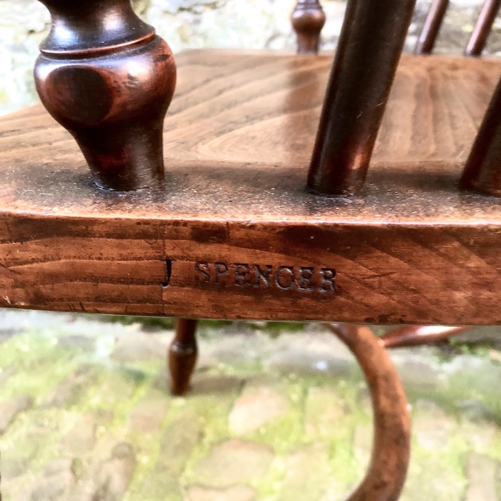 A mid-Victorian yew wood Windsor armchair featuring a hoop back, pierced central splat, turned legs, and a shaped wooden seat. View VI