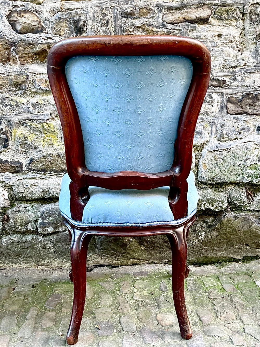 A set of four mid-19th century Louis XV style dining chairs featuring carved dark wood frames, cabriole legs, and light blue patterned fabric upholstery. View VII