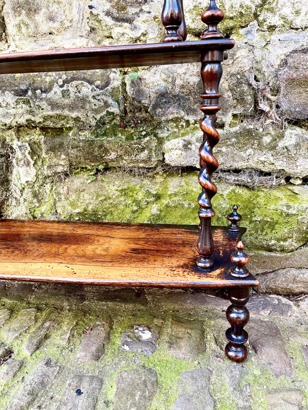 An early Victorian rosewood tiered shelf unit featuring five graduated tiers supported by turned barley twist columns and topped with finials. View III