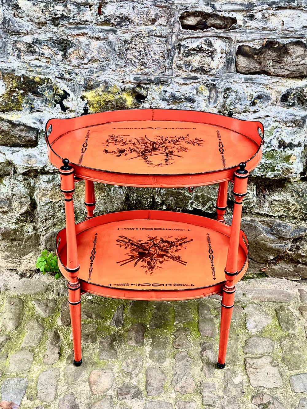 An early 20th century tole peinte two tier table
