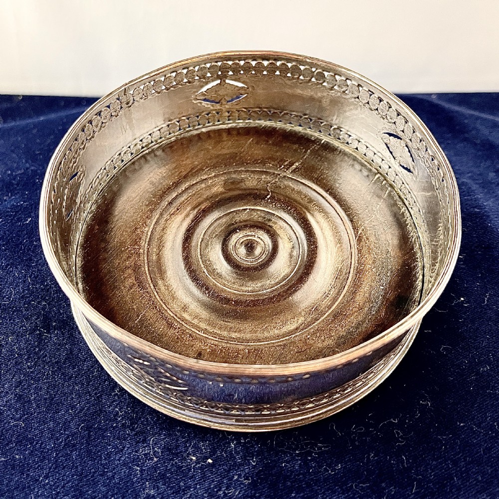 A circular Georgian Old Sheffield Plate silver wine coaster featuring hand-pierced reticulated patterns and engraved oval motif detailing. View II