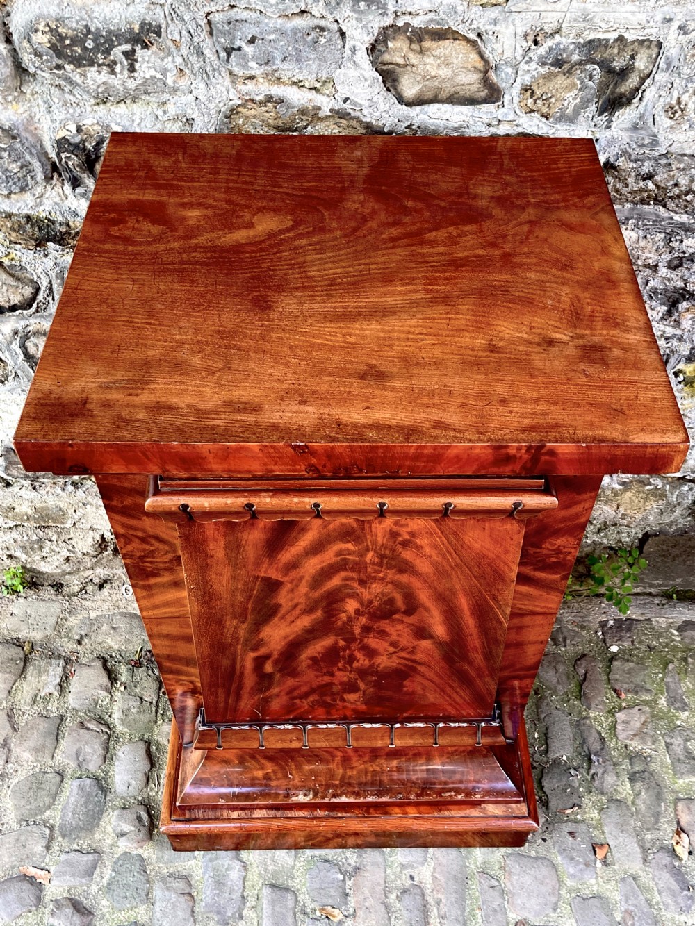 A pair of George IV flame mahogany pedestal cupboards featuring carved mouldings and plinth bases. View X