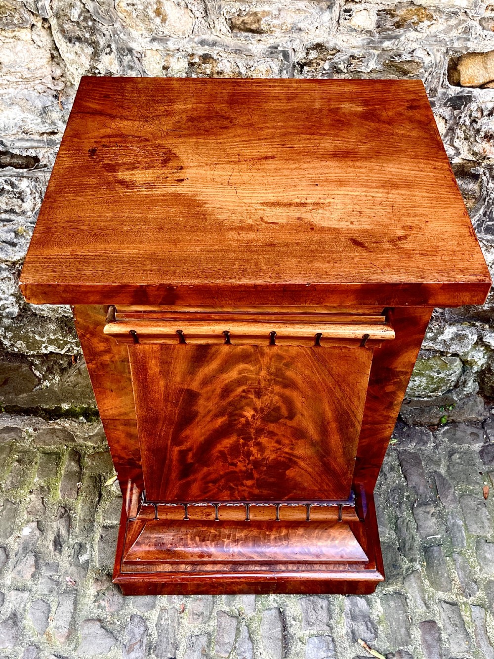 A pair of George IV flame mahogany pedestal cupboards featuring carved mouldings and plinth bases. View XI