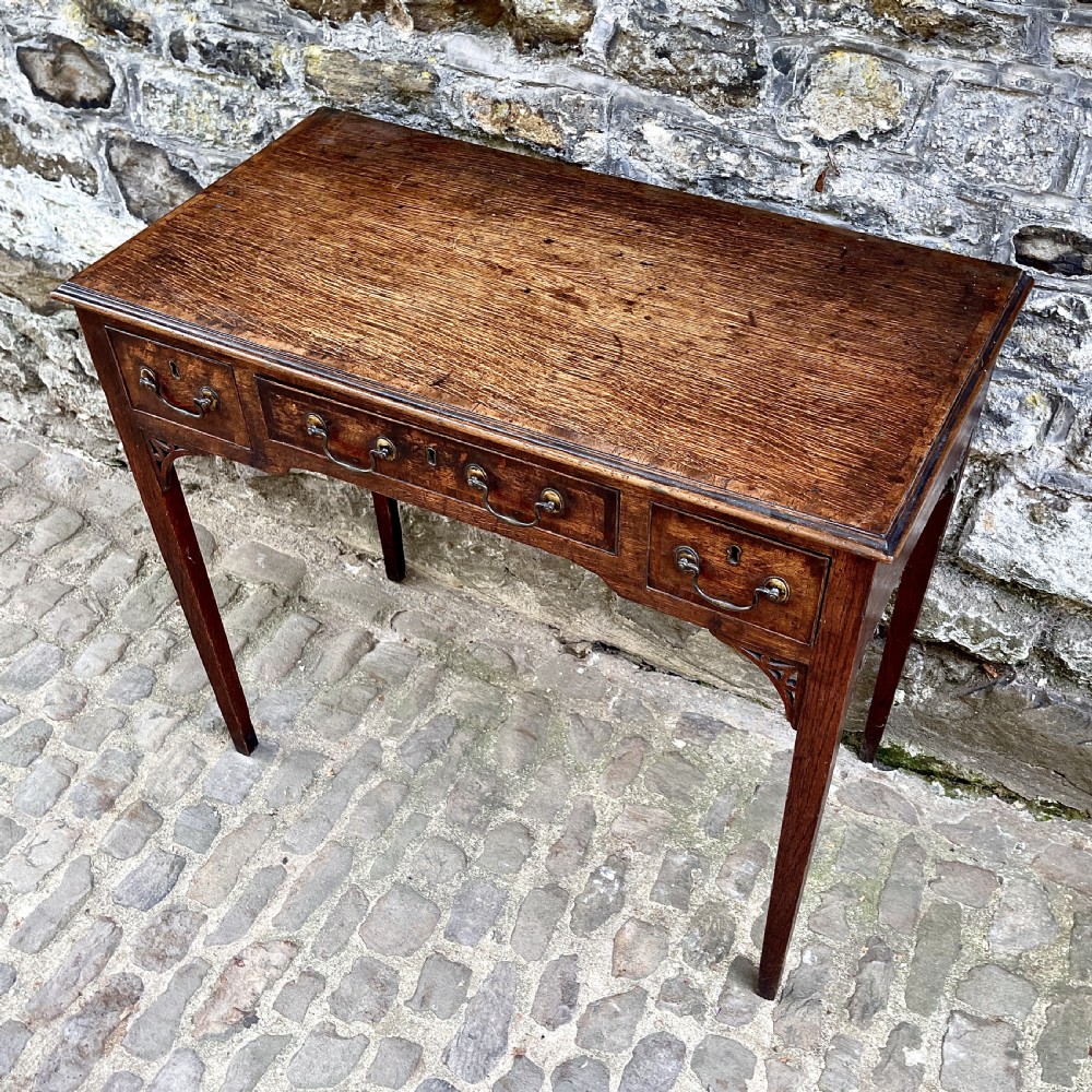 A George III oak lowboy View II