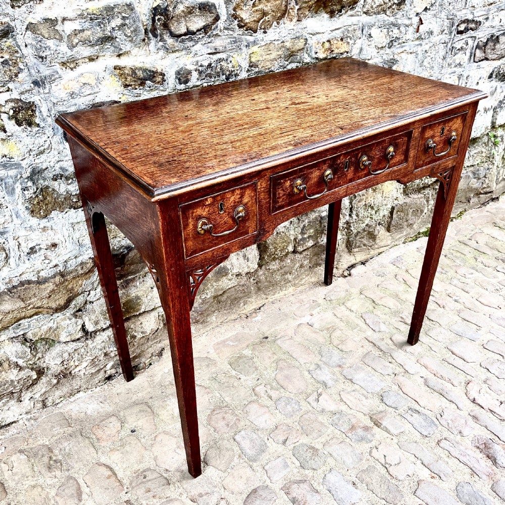 A George III oak lowboy View VII