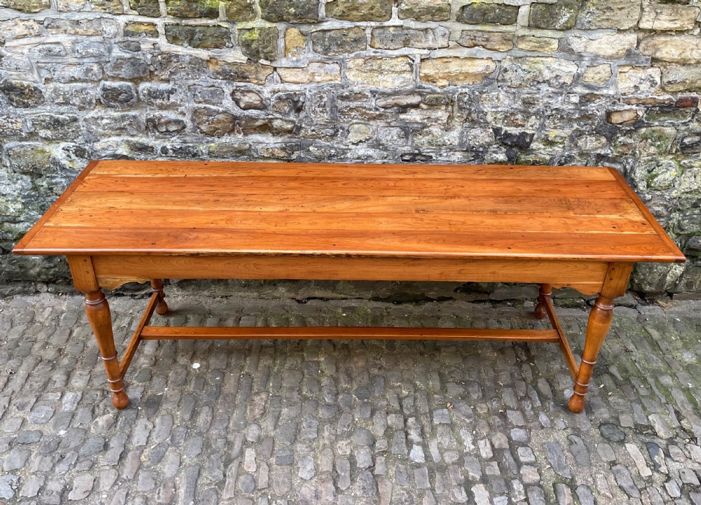 A long mid-Victorian walnut farmhouse dining table with turned legs connected by a low stretcher base. View VI