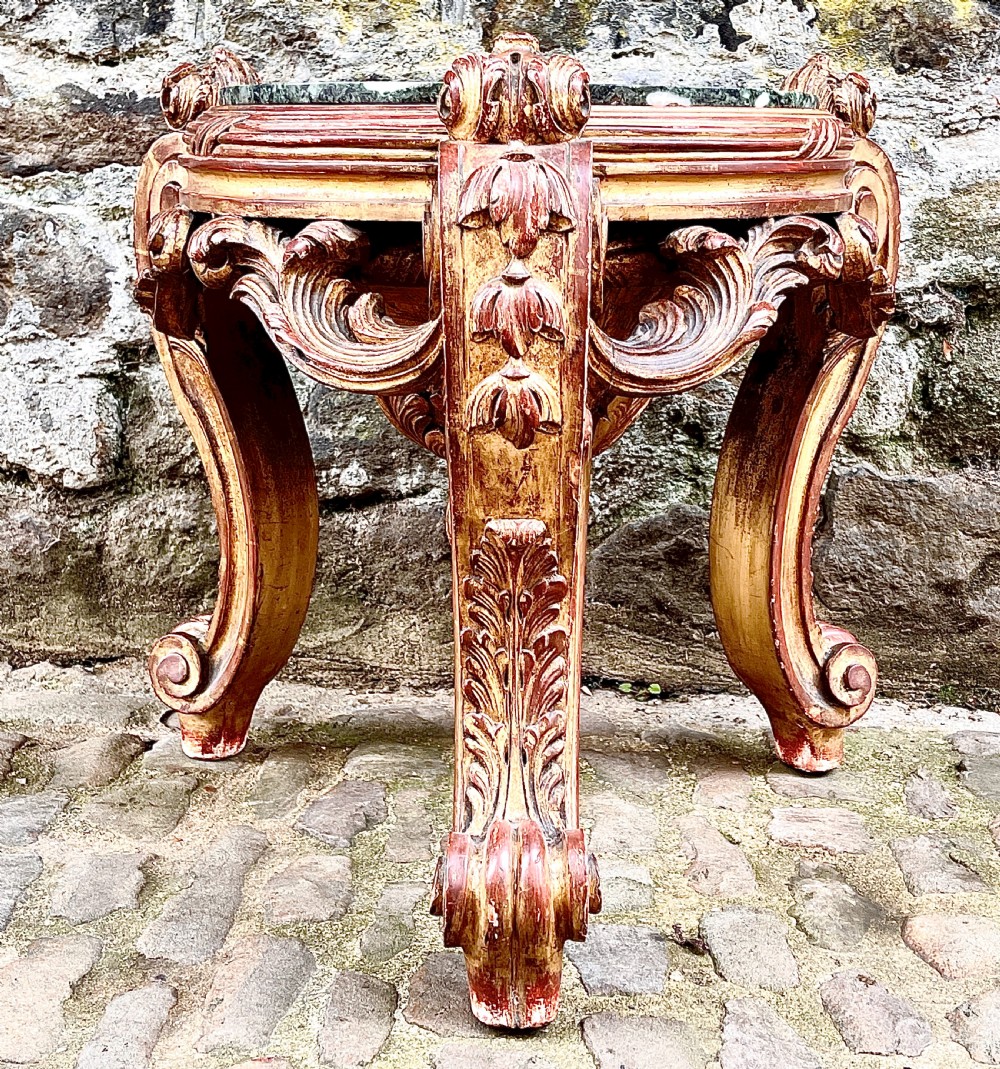 An ornate mid-19th century Italian carved giltwood pedestal stand featuring scrolling acanthus leaf legs and a circular inset green marble top. View II
