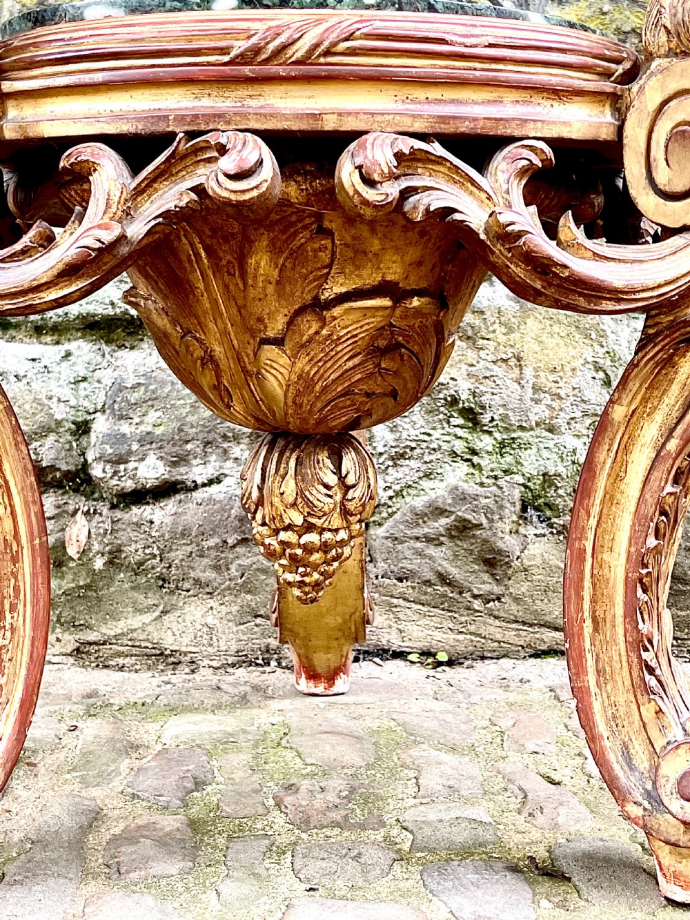 An ornate mid-19th century Italian carved giltwood pedestal stand featuring scrolling acanthus leaf legs and a circular inset green marble top. View III
