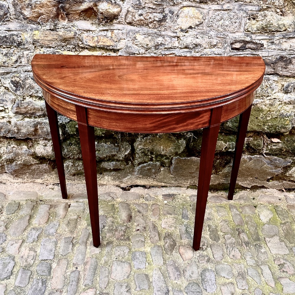 A George III Mahogany Demilune Tea Table View II