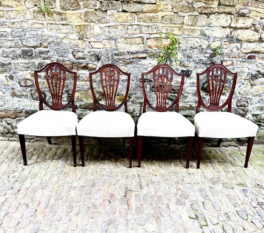 A Set of Four George III Shield Back Dining Chairs