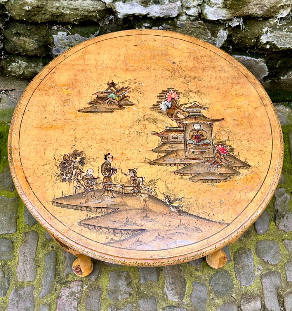 A low oval Chinoiserie coffee table featuring hand-painted East Asian landscape scenes on a cream lacquered top with cabriole legs. View VI