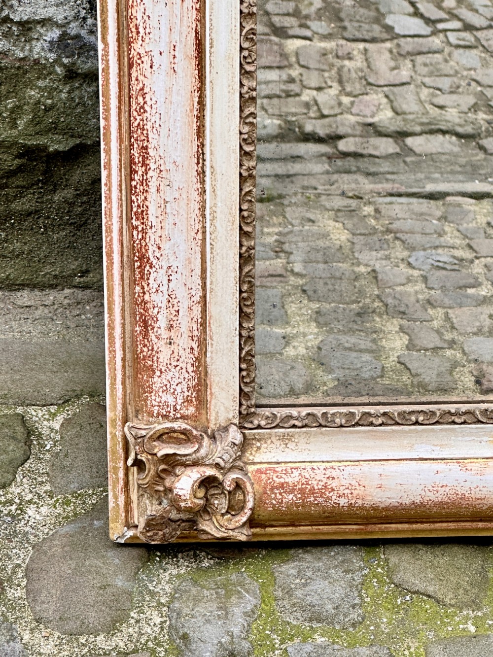 Mid 19th century arched French overmantel mirror with carved cartouche scroll cresting and a distressed cream and gold finish. View III