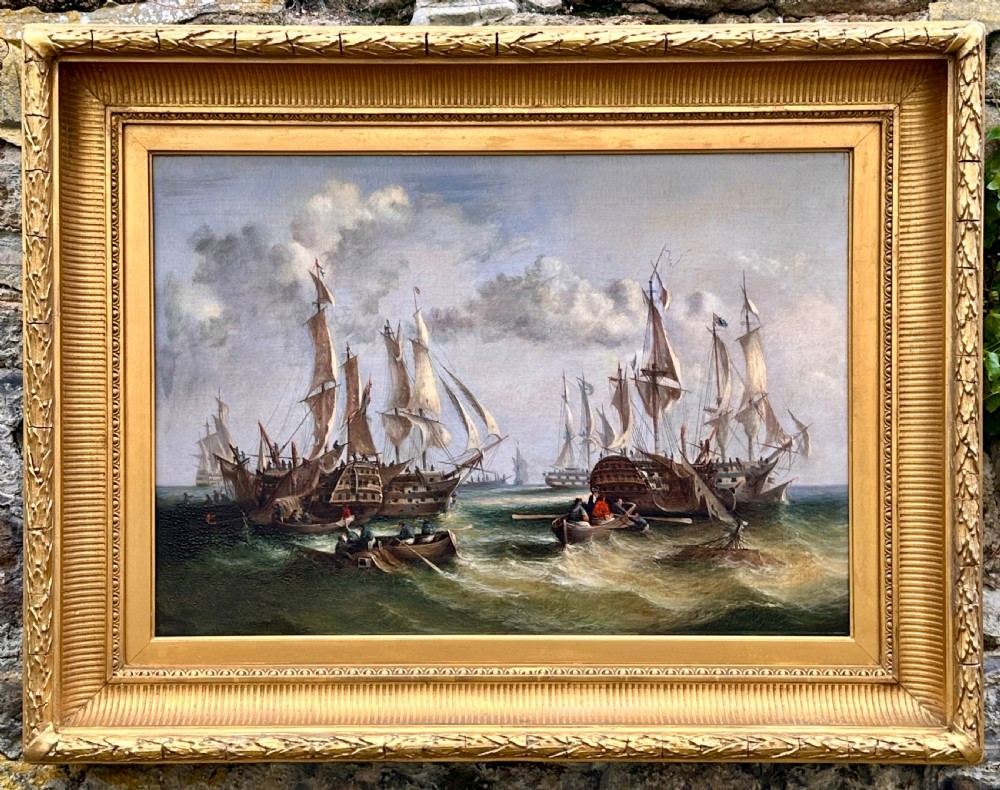 An early 19th-century marine oil painting featuring tall sailing ships in choppy seas after a battle, enclosed in an ornate gilded frame.