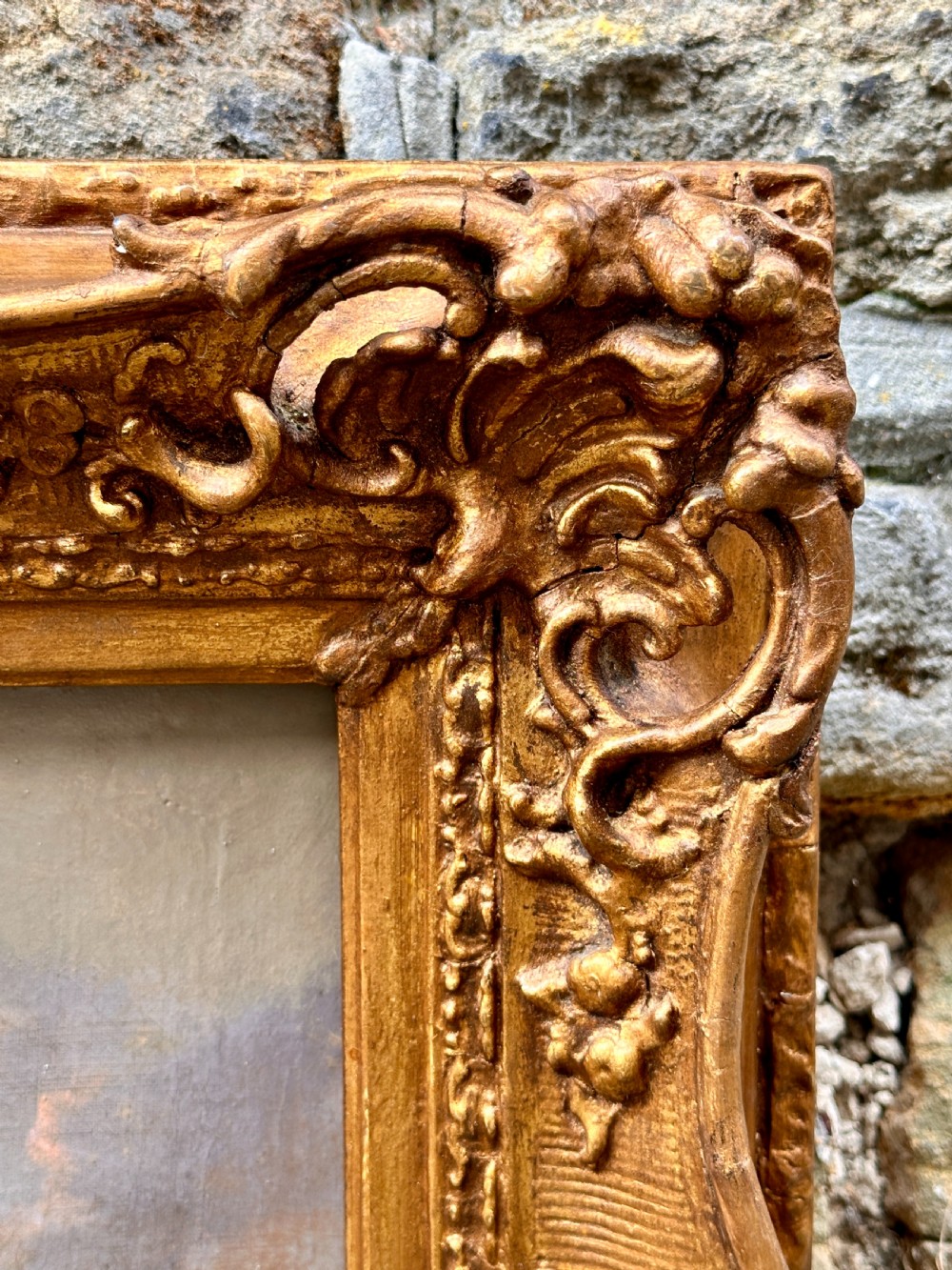 An early 19th-century English oil painting depicting a river landscape with a waterfall and mountains, set in a carved gilt frame. View III