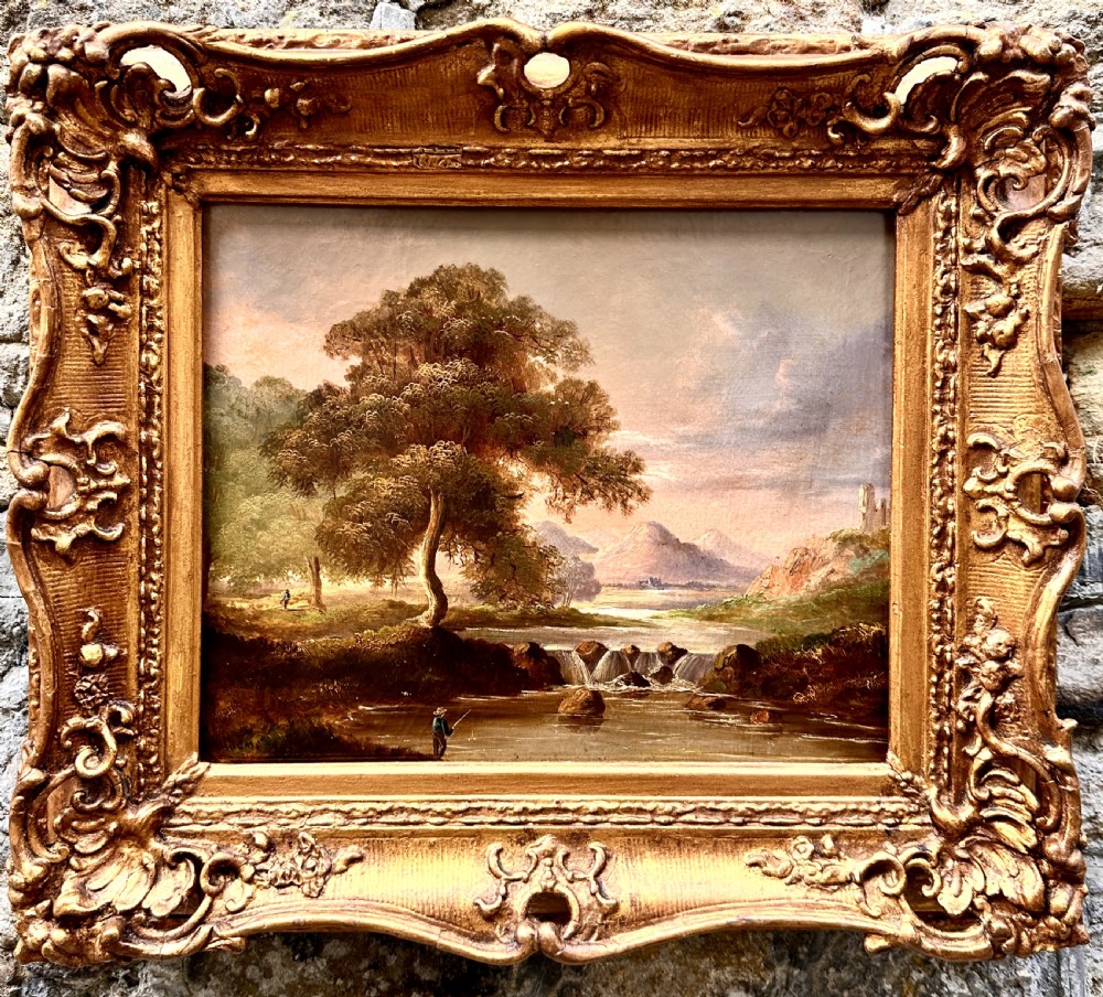 An early 19th-century English oil painting depicting a river landscape with a waterfall and mountains, set in a carved gilt frame. View V