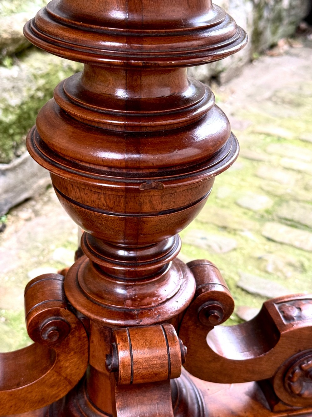 An octagonal mid-Victorian centre table crafted from walnut with a veneered top, turned pedestal stem, and carved four-legged scroll base. View VII