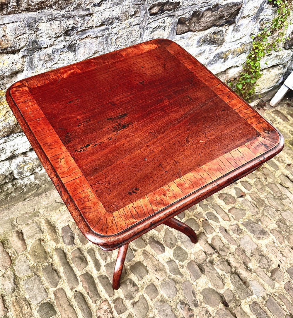 A Regency birchwood lamp table featuring a crossbanded top with rounded corners, a central turned column, and four splayed legs. View III
