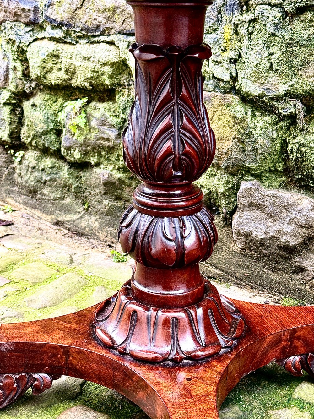 A William IV flame mahogany work table featuring a gadrooned top edge, two drawers with bone escutcheons, a carved pedestal stem, and a quadform base with claw feet. View V