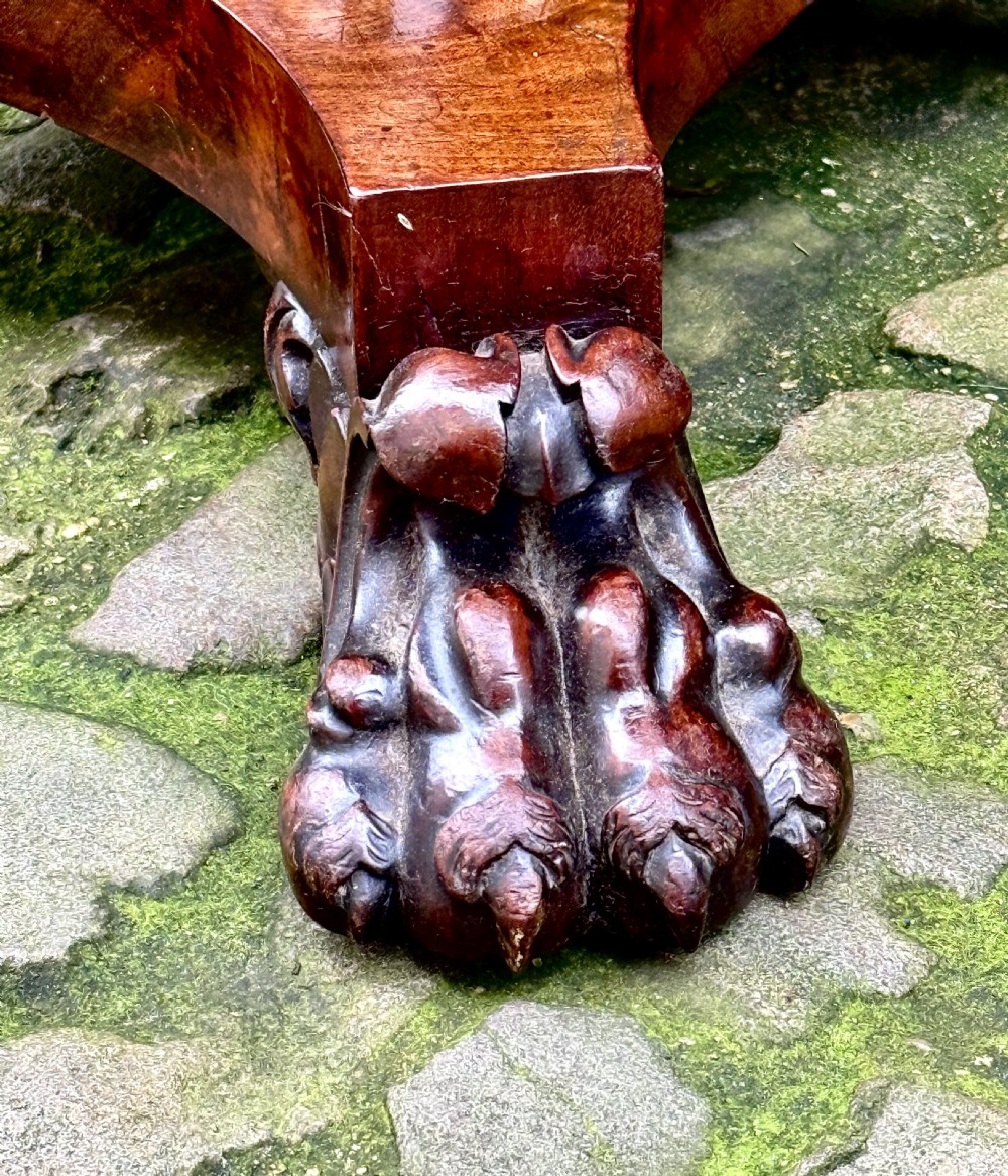 A William IV flame mahogany work table featuring a gadrooned top edge, two drawers with bone escutcheons, a carved pedestal stem, and a quadform base with claw feet. View VII