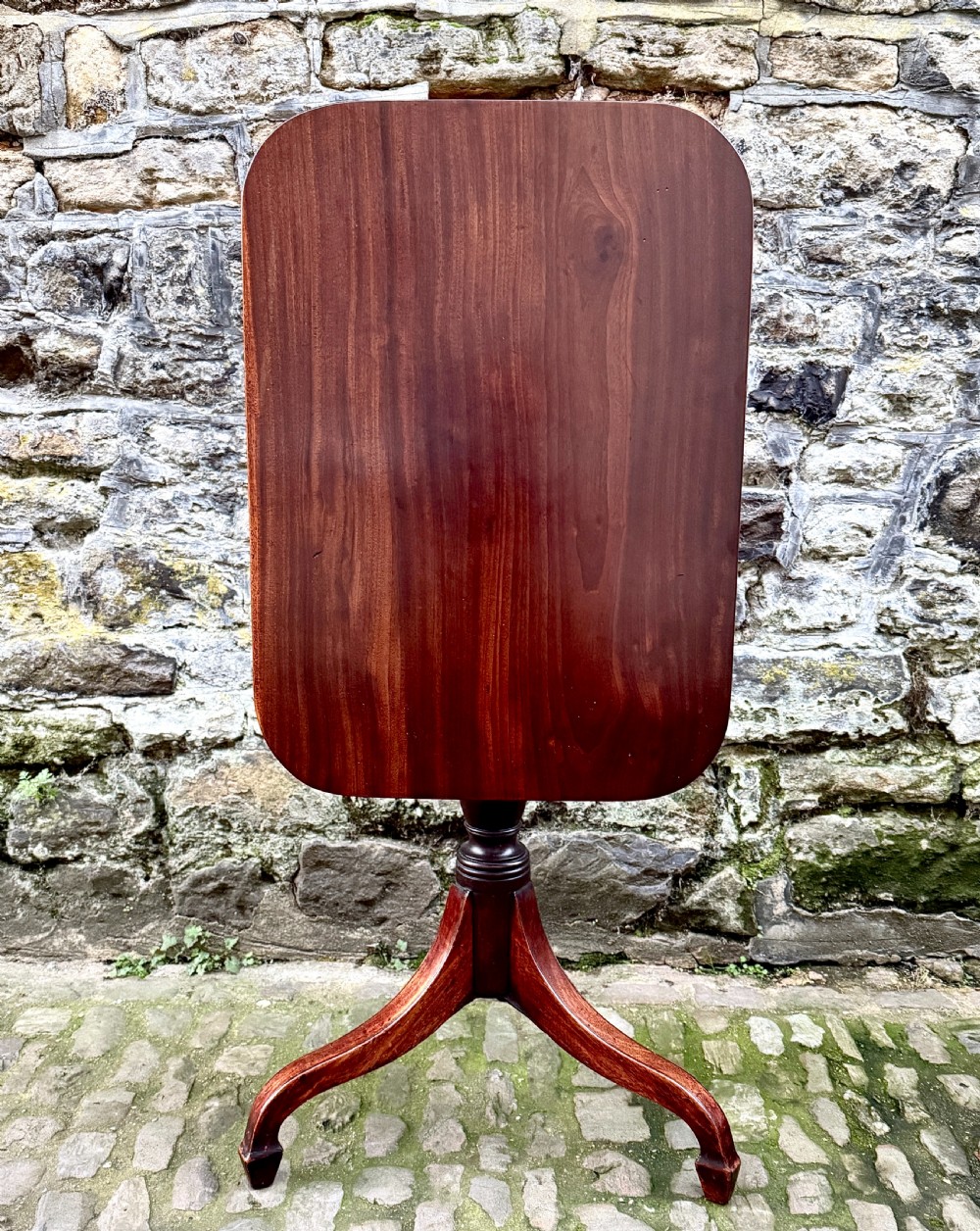 A Regency mahogany tripod side table featuring a rounded rectangular top supported by a turned central pedestal and three splayed legs. View IV