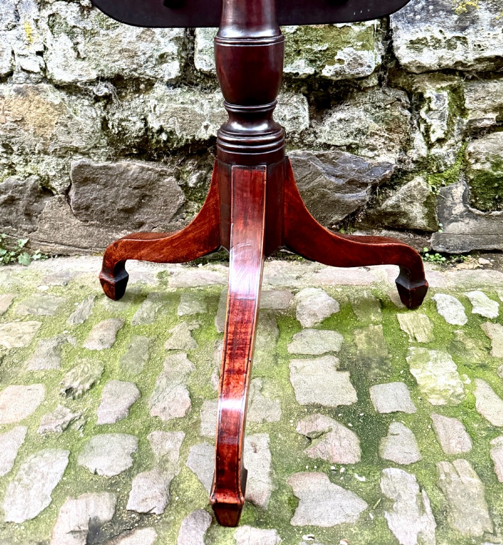 A Regency mahogany tripod side table featuring a rounded rectangular top supported by a turned central pedestal and three splayed legs. View VI