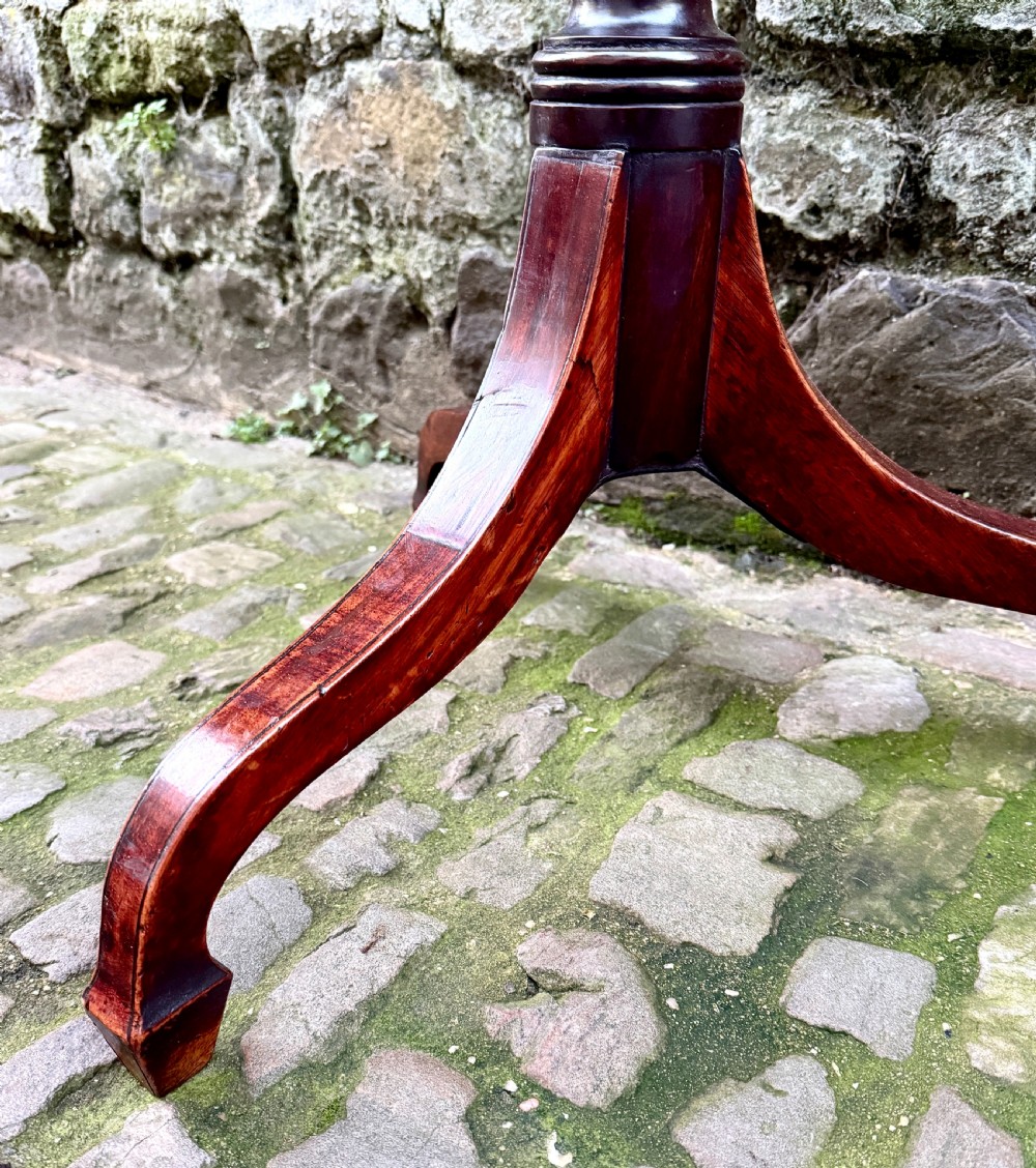 A Regency mahogany tripod side table featuring a rounded rectangular top supported by a turned central pedestal and three splayed legs. View VII