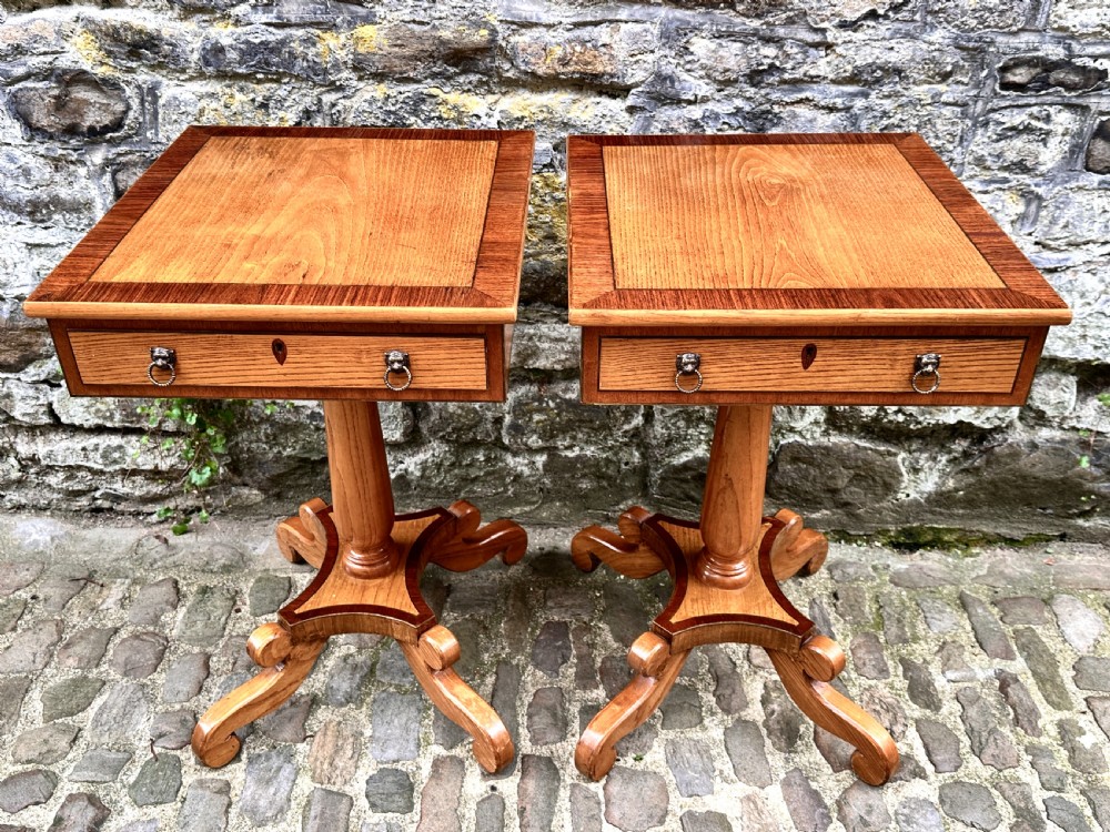 A pair of early 20th century ash pedestal side tables featuring single drawers with brass lion mask ring handles and quadruped scrolled bases. View VII